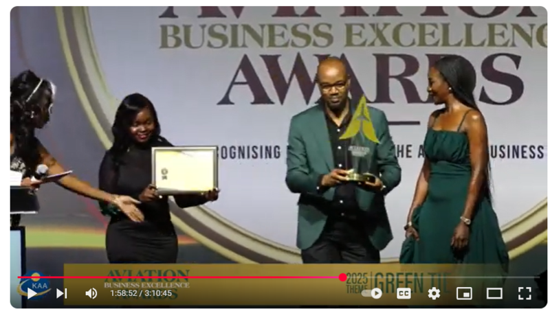 Two people receiving an award during a ceremony