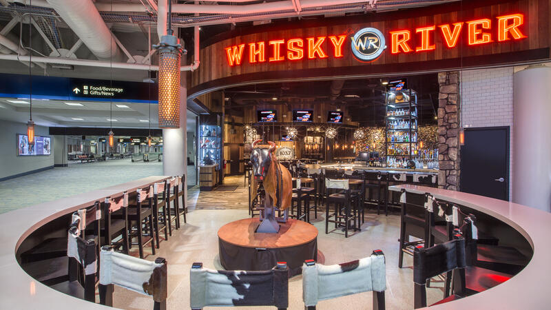 Whisky River restaurant featuring a rounded front counter accompanied by high bar stools.