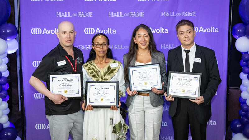 A group of four people receiving an award.