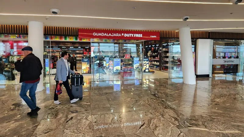 People passing by a duty free shop inside an airport