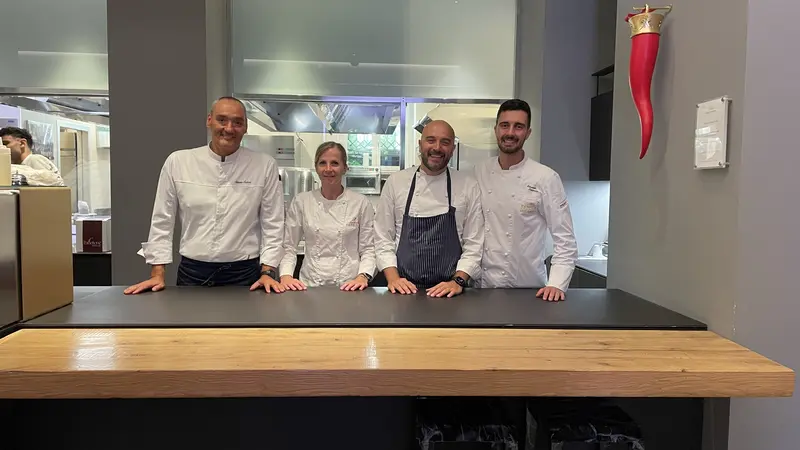 Four chef behind a counter.