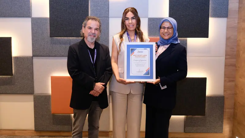 Three people receiving an award.