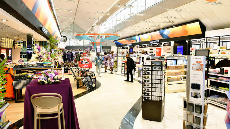 A duty free in an airport with shelves and diplays