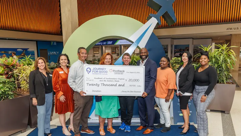 A group of people showing a big check sample