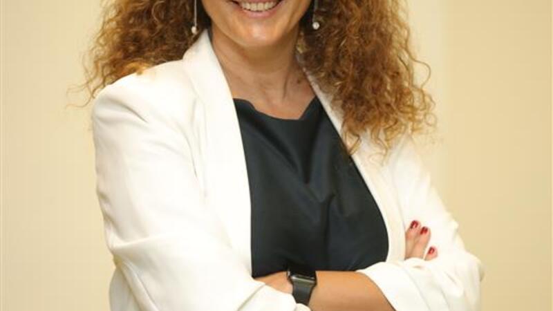 A Blonde woman with a white jacket and black shirt