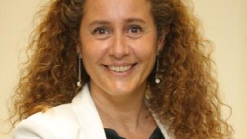 A Blonde woman with a white jacket and black shirt