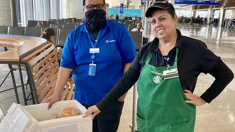 Two associates in the back end of a store.
