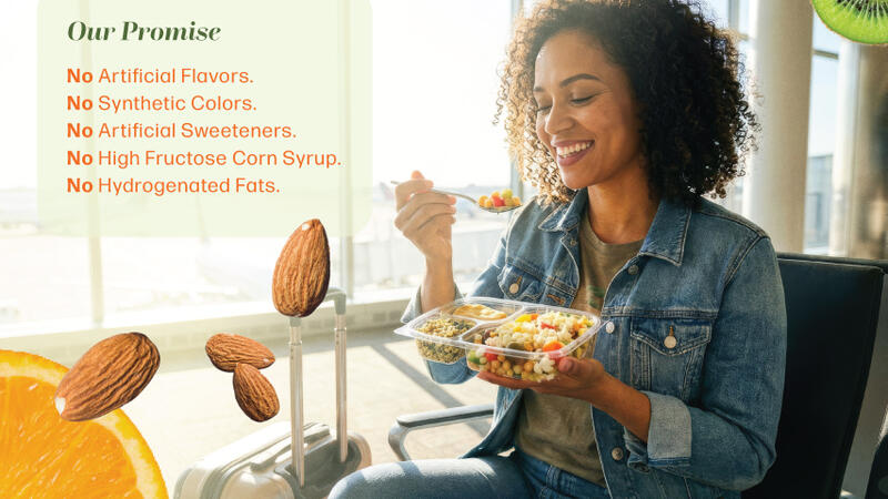 A girl sitting at a table eating a salad