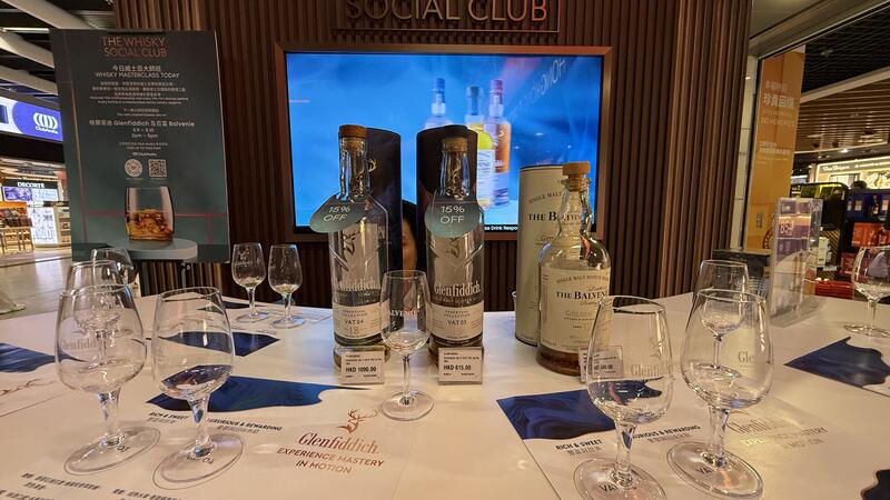 Glasses and bottles of whisky on a table.