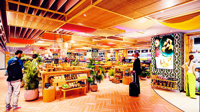 A woman with a basket walking through a duty free
