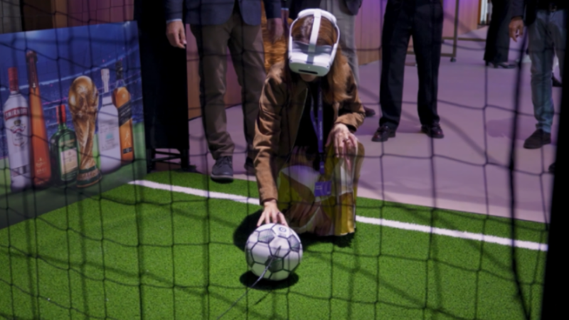 A woman playing with IA glasses and a ball