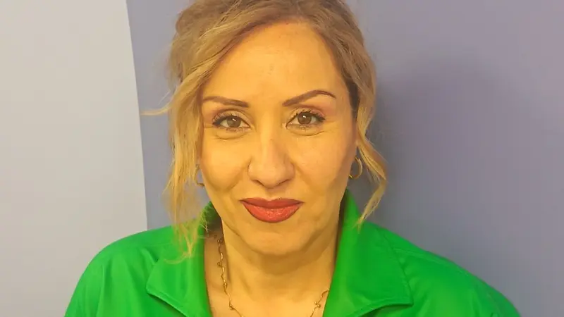 A blonde woman with a green shirt