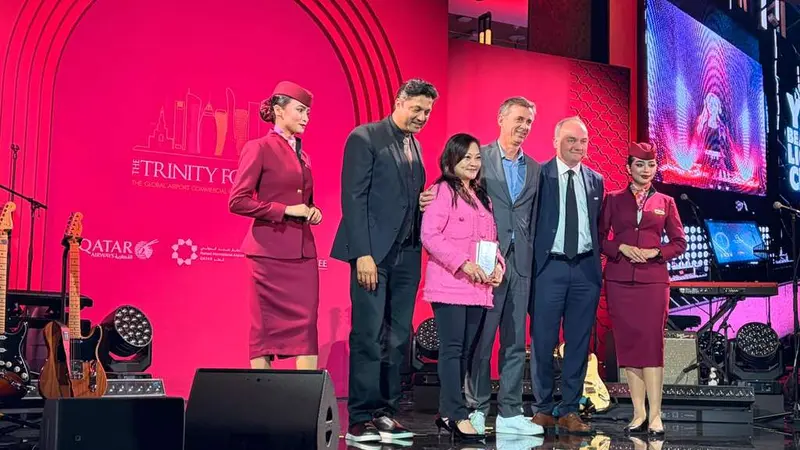 People on a stage receiving a plate for an award.