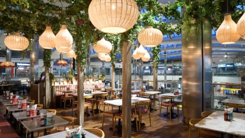 A restaurant with plants and tables