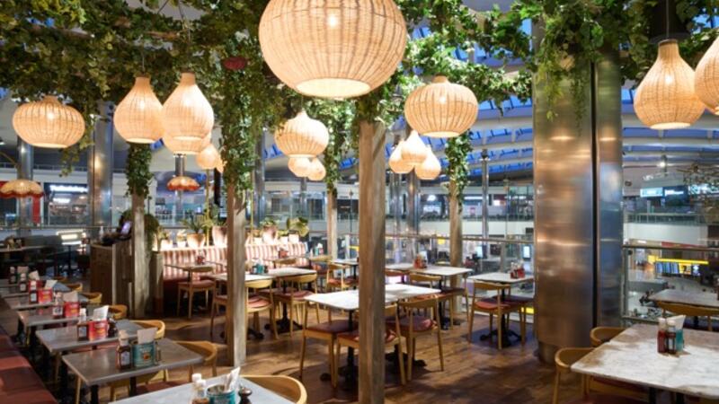 A restaurant with plants and tables