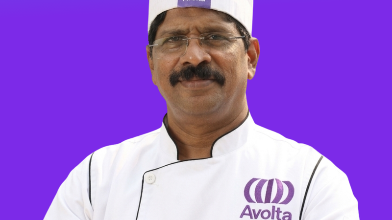 A man with mustaches and a chef cap