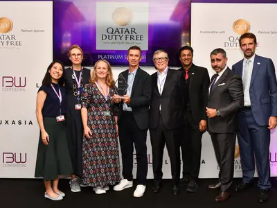 A group posing proudly with an award received at Cannes.