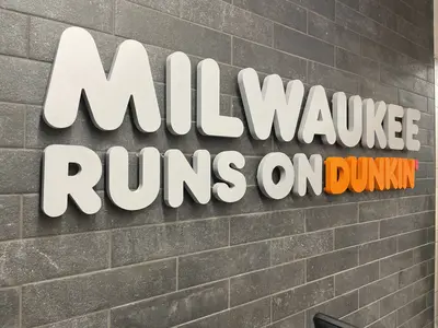 Wall lettering featuring "Milwaukee Dunkin’" inside the store.
