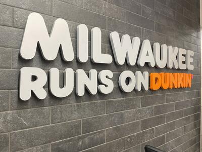 Wall lettering featuring "Milwaukee Dunkin’" inside the store.