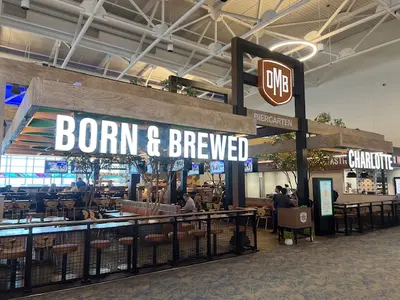 Entrance to OMB Biergarten restaurant with a wood arch.