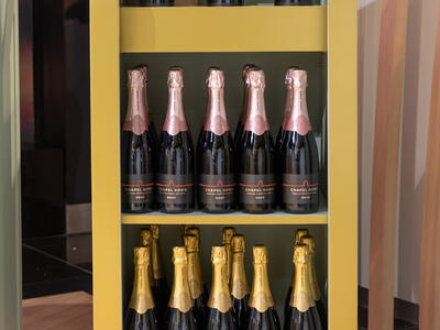 A shelf with bottles of sparkling wines