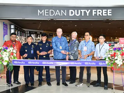 A group of people cutting a ribbon for the opening of a store