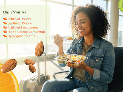 A girl sitting at a table eating a salad