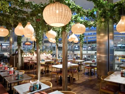 A restaurant with plants and tables