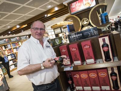 Dufry launches first ever airport exclusive Single Cask Speyside Single Malt whisky - Sandy McIntyre Tamdhu Distillery Manager signing bottles - World Duty Free - Dufry