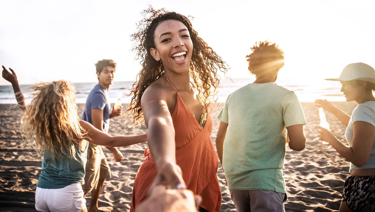 5 Young people dancing on a beach