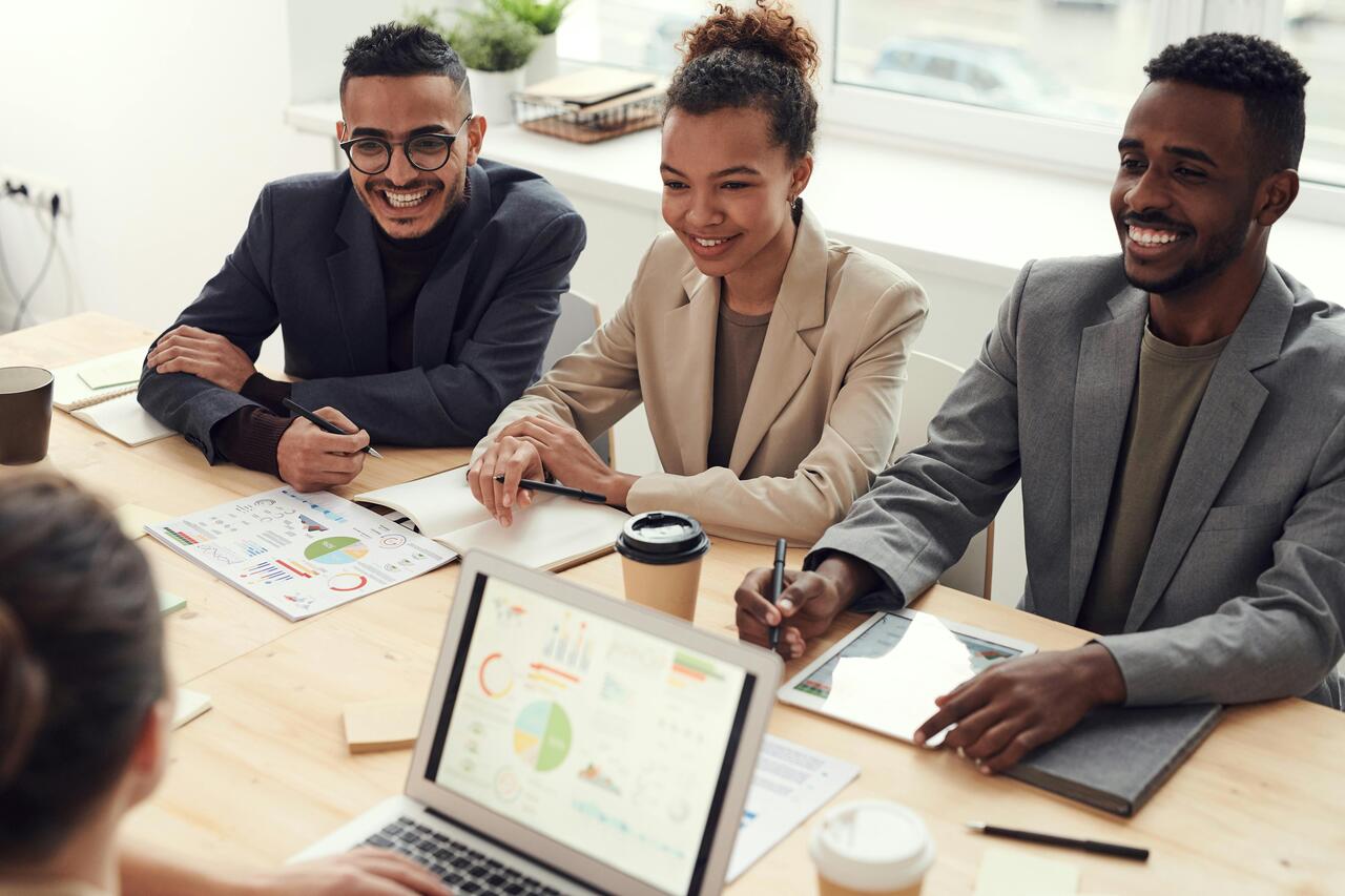 colleagues at desk discussing presentation