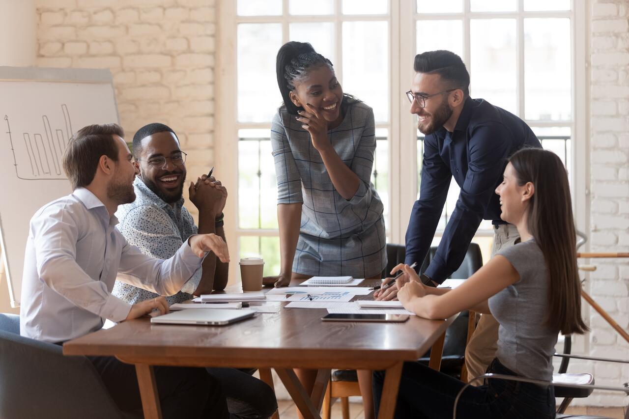 A group of people speaking around a table.