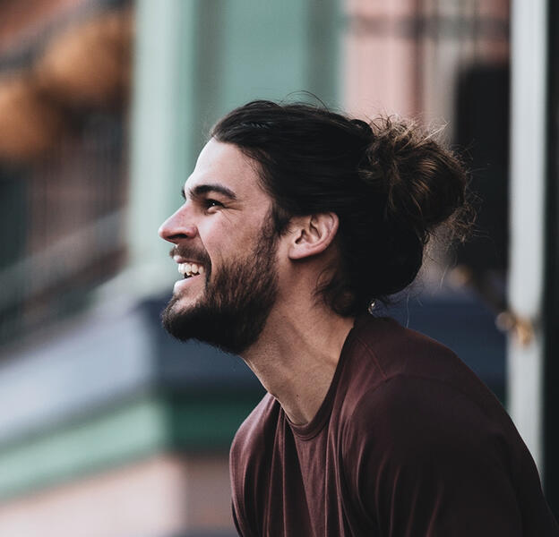 a dark haired man smiling