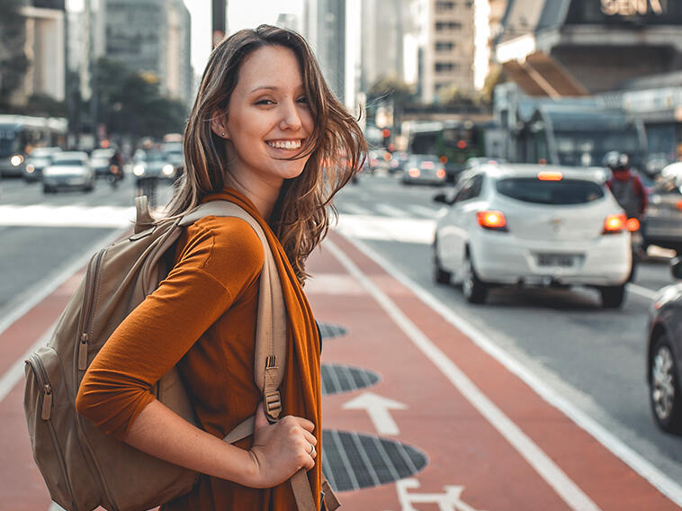 a female traveller with a backpack in an urban setting